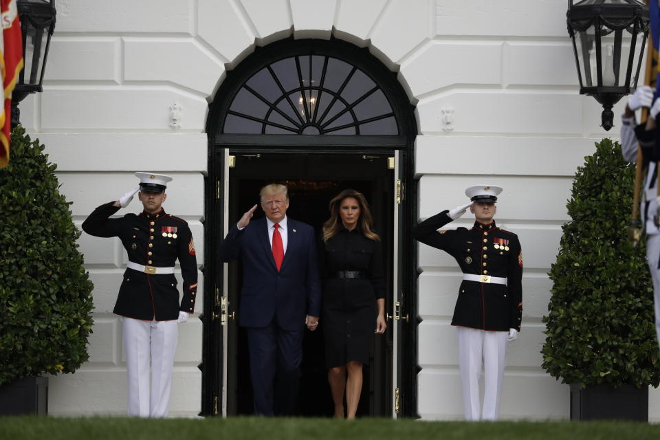 President Donald Trump and first lady Melania Trump walk out to participate in a moment of silence honoring the victims of the Sept. 11 terrorist attacks, on the South Lawn of the White House, Wednesday, Sept. 11, 2019, in Washington. (AP Photo/Evan Vucci)