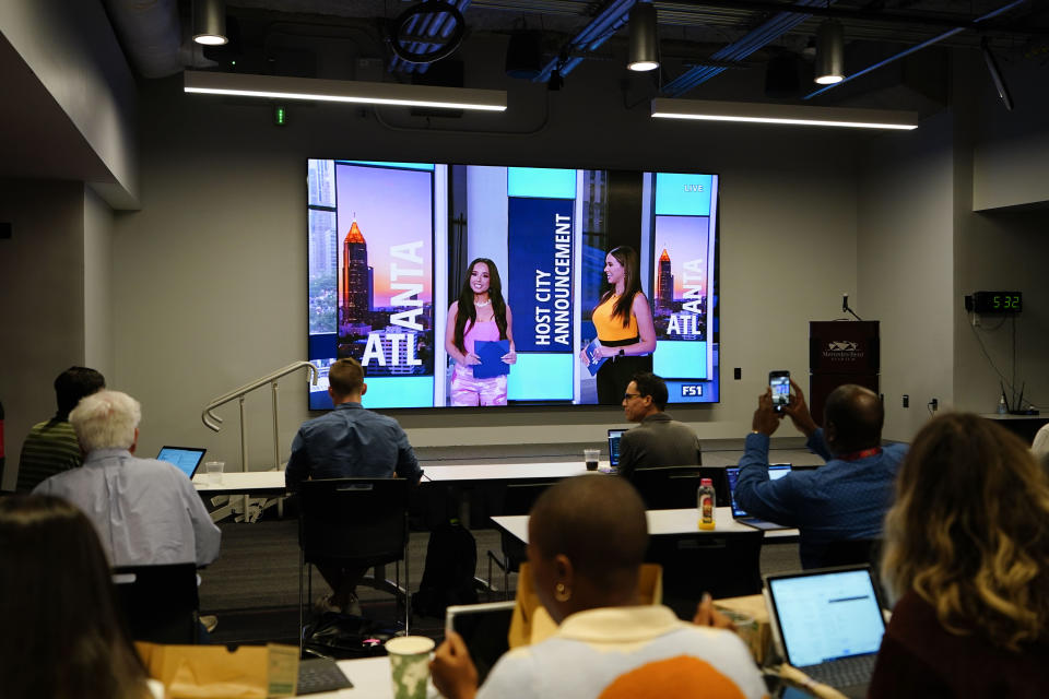 People watch as FIFA announces Atlanta as a 2026 World Cup host city, Thursday, June 16, 2022, in Atlanta. (AP Photo/Brynn Anderson)