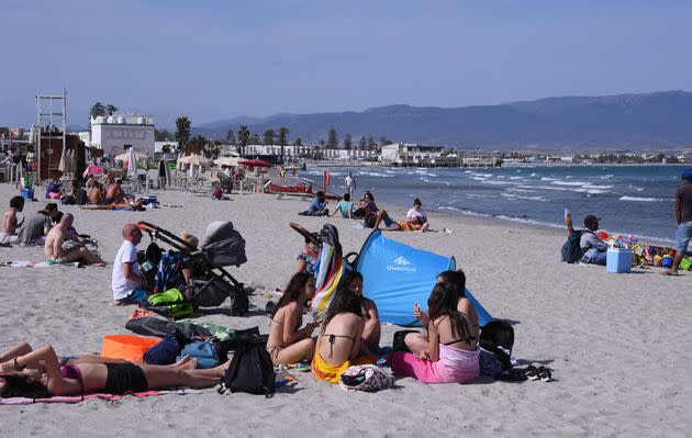 People relax on a beach in Cagliari, Sardinia, Italy, on May 28, 2021. All Italian regions have turned to 