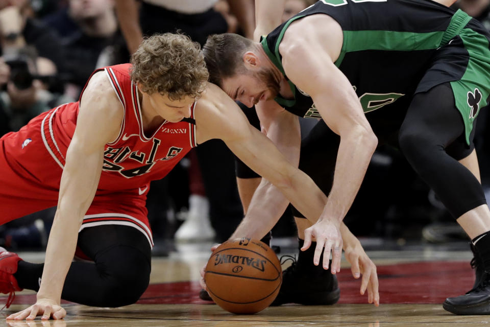 Chicago Bulls forward Lauri Markkanen, left, and Boston Celtics forward Gordon Hayward compete for the ball during the first half of an NBA basketball game in Chicago, Saturday, Jan. 4, 2020. (AP Photo/Nam Y. Huh)