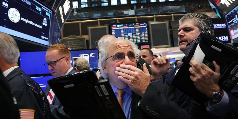 Traders work on the floor of the New York Stock Exchange (NYSE)