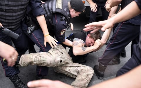 Police arrest a man at the protest inspired by the case against journalist Ivan Golunov - Credit: Alexander Nemenov/AFP