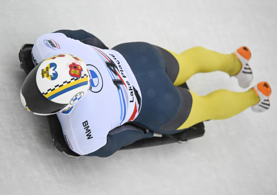 Vladyslav Heraskevych, of Ukraine, takes a turn during the first run of the men's skeleton World Cup race on Friday, Dec. 16, 2022, in Lake Placid, N.Y. (AP Photo/Hans Pennink)