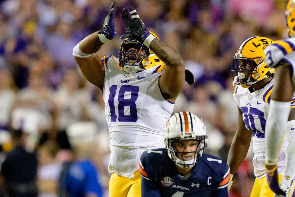 Oct 14, 2023; Baton Rouge, Louisiana, USA; LSU Tigers defensive tackle Mekhi Wingo (18) reacts after tackling Auburn Tigers quarterback Payton Thorne (1) during the second quarter at Tiger Stadium. Mandatory Credit: Matthew Hinton-USA TODAY Sports