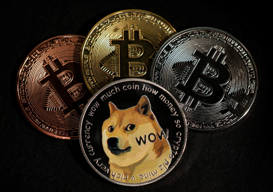 Representations of the Bitcoin and Dogecoin cryptocurrencies are seen in this picture illustration taken June 7, 2021. REUTERS/Edgar Su/Illustration