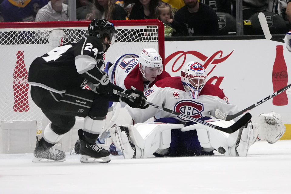 Montreal Canadiens goaltender Jake Allen, right, stops a shot behind Los Angeles Kings center Phillip Danault during the third period of an NHL hockey game , Saturday, Nov. 25, 2023, in Los Angeles. (AP Photo/Marcio Jose Sanchez)