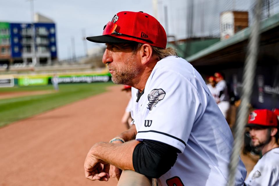 Lugnuts' manager Craig Conklin looks on from the dugout before the home opener against the Whitecaps on Tuesday, April 11, 2023, at Jackson Field in Lansing.