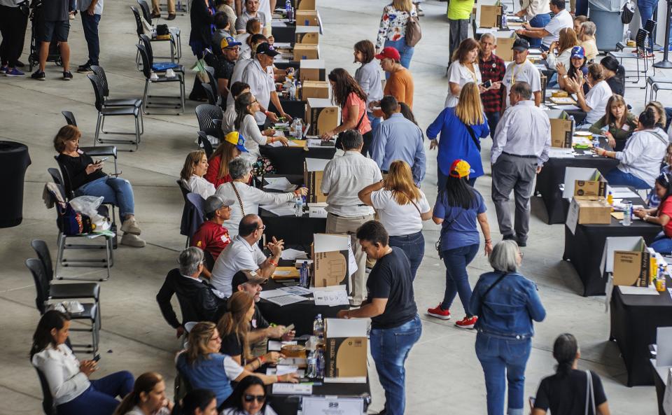 Thousands of exiled Venezuelans participated in the primaries elections to choose the opposition's candidate for next year's presidential election in Doral, Fla., on Sunday, Oct. 22, 2023. (Pedro Portal/Miami Herald via AP)