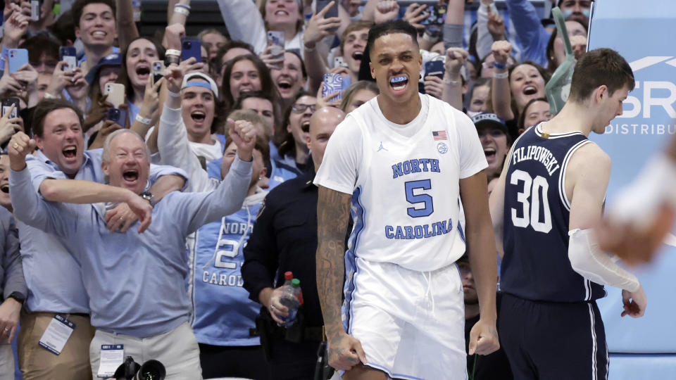 North Carolina forward Armando Bacot (5) and the fans celebrate after he dunked in the final moments as Duke center Kyle Filipowski (30) walks away during the second half of an NCAA college basketball game Saturday, Feb. 3, 2024, in Chapel Hill, N.C. (AP Photo/Chris Seward)