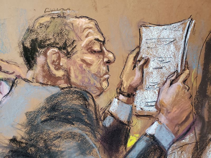 Harvey Weinstein sits at the defense table reading papers during jury deliberations in his sexual assault trial