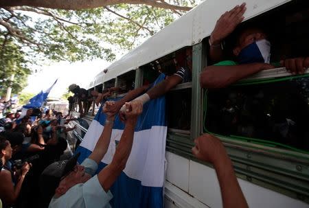 University students are welcomed during their arrival at the Metropolitan Cathedral after they were freed after being trapped overnight in Divine Mercy Catholic Church where they took shelter as pro-government gunmen shot at them at the National Autonomous University of Nicaragua (UNAN), in Managua, Nicaragua July 14, 2018. REUTERS/Oswaldo Rivas