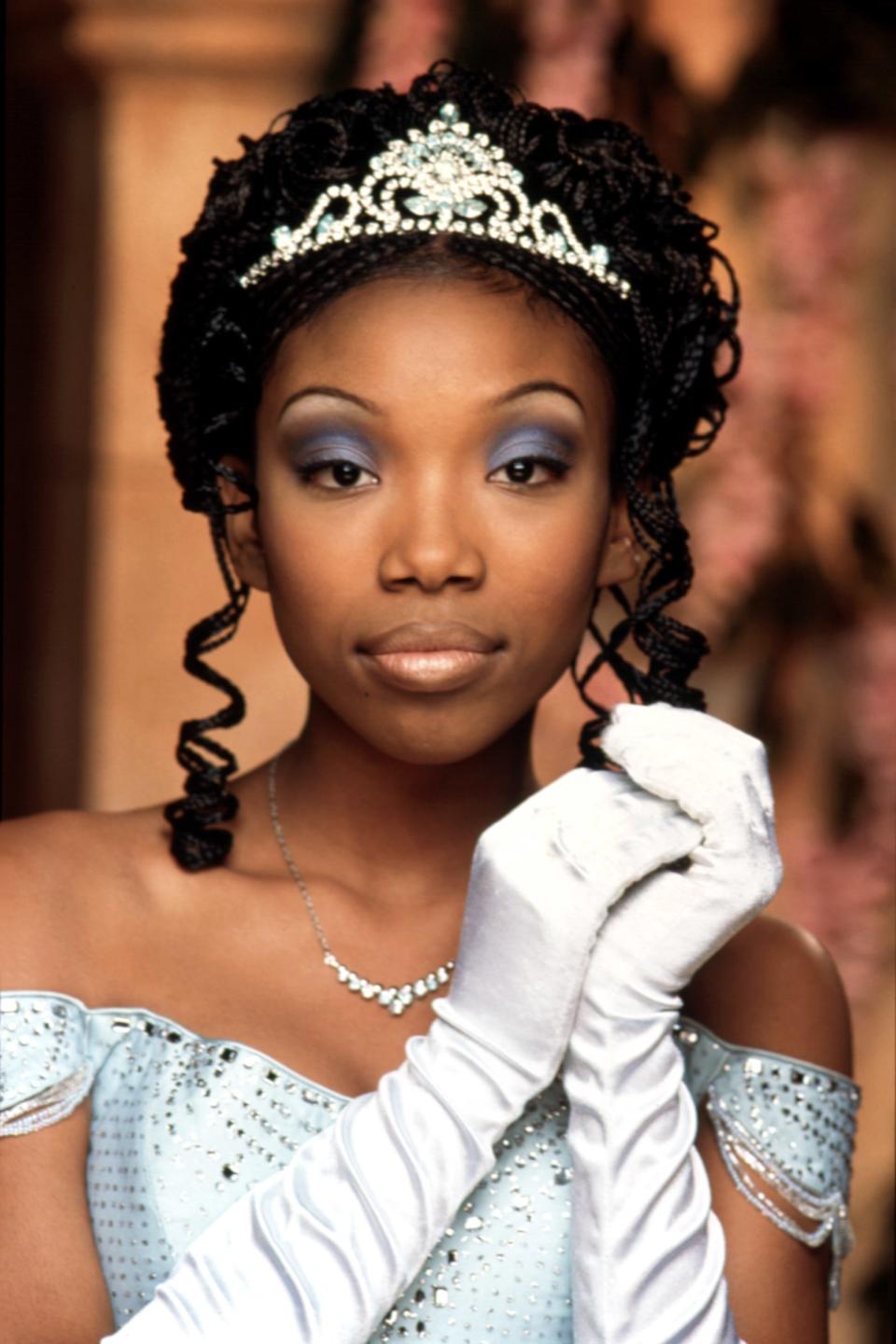 Brandy as Cinderella in a pale blue gown and tiara, wearing white gloves