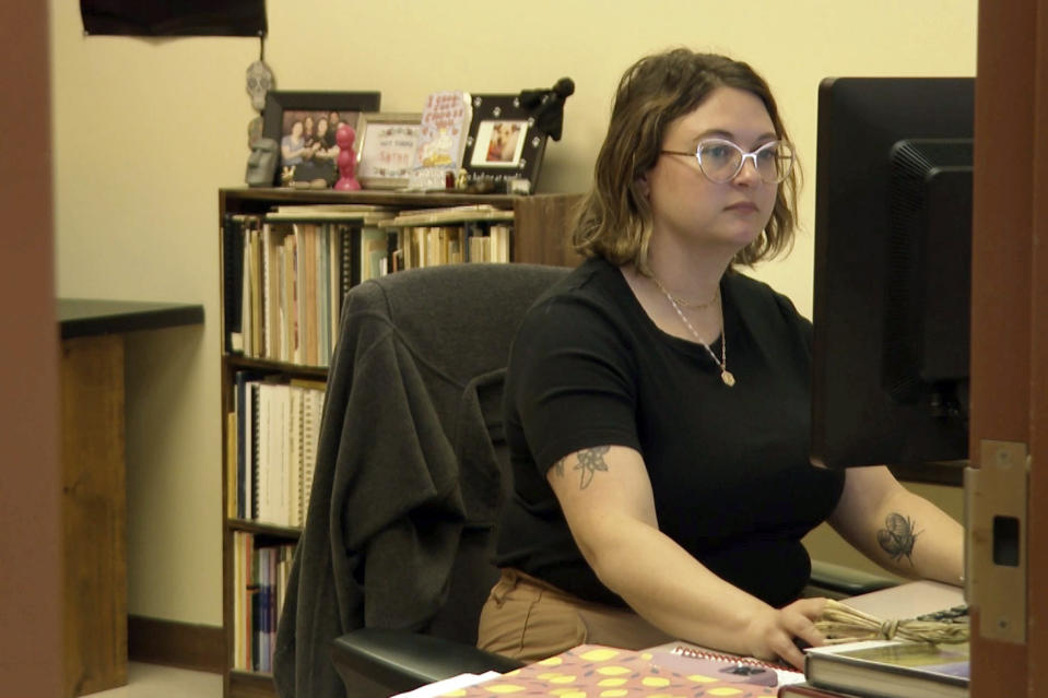 In this image taken from video, Brooke Morgan, curator of anthropology at the Illinois State Museum, sits her desk at the museum in Springfield, Ill, on Aug. 18, 2023. Illinois officials and Native Americans whose ancestors called the state home hope a new state law will speed the recovery and reburial of ancestors' remains unearthed over the past two centuries. Morgan said the law ensures the return of remains to the land on which they were intended to rest. (AP Photo/Melissa Winder)