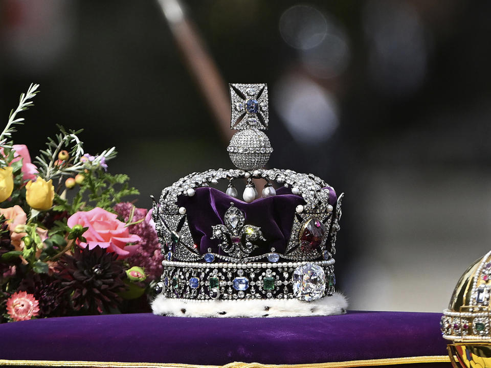 FILE - The Imperial S tate crown and the sovereign's orb and scepter, is seen during the state funeral of late Queen Elizabeth II in London, Monday, Sept. 19, 2022. Two stones cut from the Cullinan Diamond, the largest rough diamond ever found, will feature prominently in King Charles III coronation ceremony on Saturday, May 6, 2023. Cullinan I, a huge drop-shaped stone weighing 530.2 carats, is mounted in the Sovereign’s Sceptre with Cross. Cullinan II, a cushion-shaped gem of 317.4 carats, is mounted on the front of the Imperial State Crown that Charles will wear as he leaves Westminster Abbey. (Jeff Spicer/Pool Photo via AP)