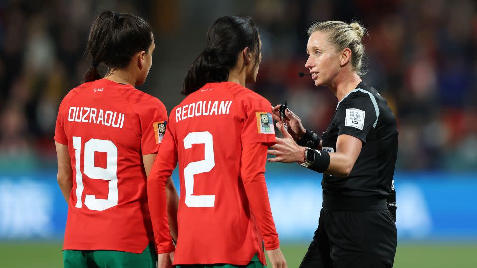 Penso talks to Sakina Ouzraoui and Zineb Redouani of Morocco during the Women's World Cup round-of-16 match between France and Morocco. - Sarah Reed/Getty Images