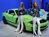 Models Lindsey Rae (L) and Lynsey Ramade pose with a Ford Mustang Boss 302 during the final press preview day for the North American International Auto Show in Detroit, Michigan, January 10, 2012. REUTERS/Mike Cassese