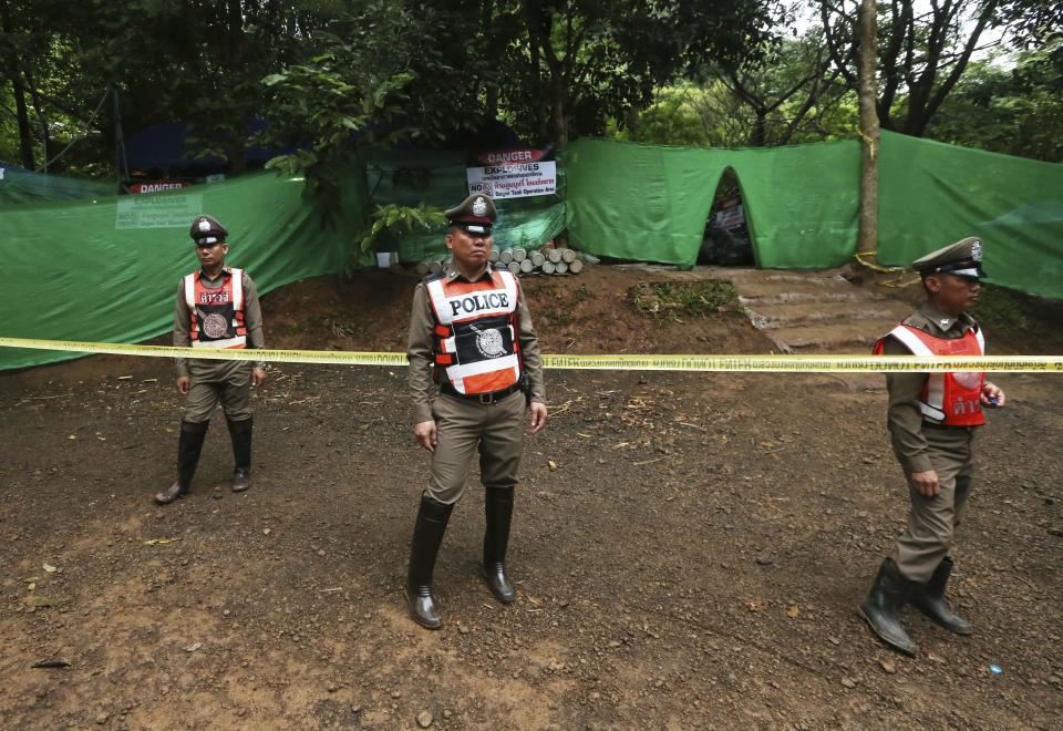 Thai policemen stand guard near a cave where the boys have been trapped for two weeks. Source: AP