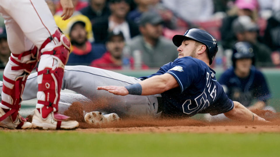 Tampa Bay Rays' Luke Raley slides safely to score on a single by Manuel Margot during the fifth inning of a baseball game against the Boston Red Sox at Fenway Park, Monday, June 5, 2023, in Boston. (AP Photo/Charles Krupa)