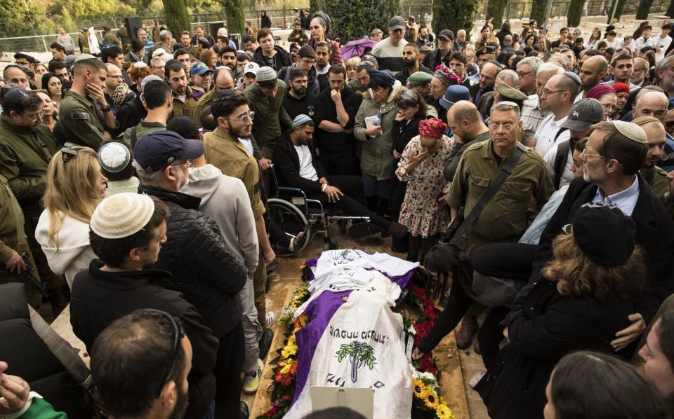 Family and friends mourn during a funeral for Sgt. 1st Class Amichai Yisrael Yehoshua Oster
