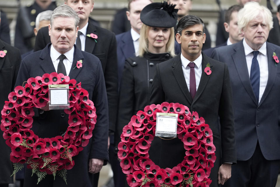 FILE - Britain's Prime Minister Rishi Sunak, second right, holds a wreath as he stands with Labour Party leader Keir Starmer, left, former Prime Ministers Liz Truss, third right, and Boris Johnson, right, to attend the Remembrance Sunday ceremony at the Cenotaph on Whitehall in London, on Nov. 12, 2023. If opinion polls giving Labour a consistent double-digit lead are borne out on election day, Starmer will become Britain's first Labour prime minister since 2010. (AP Photo/Kin Cheung, Pool, File)