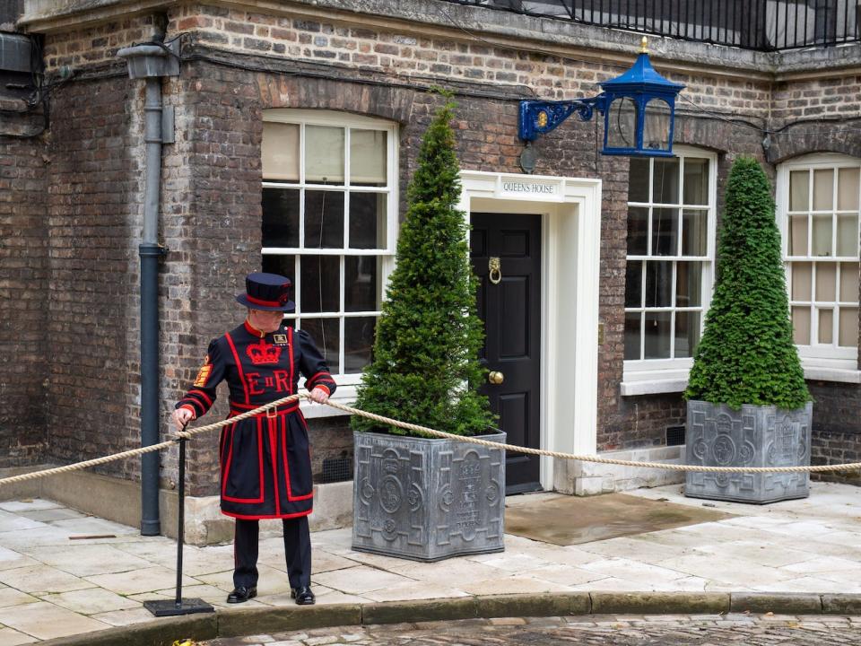 A tower guard sets out ropes outside the Queen's House.