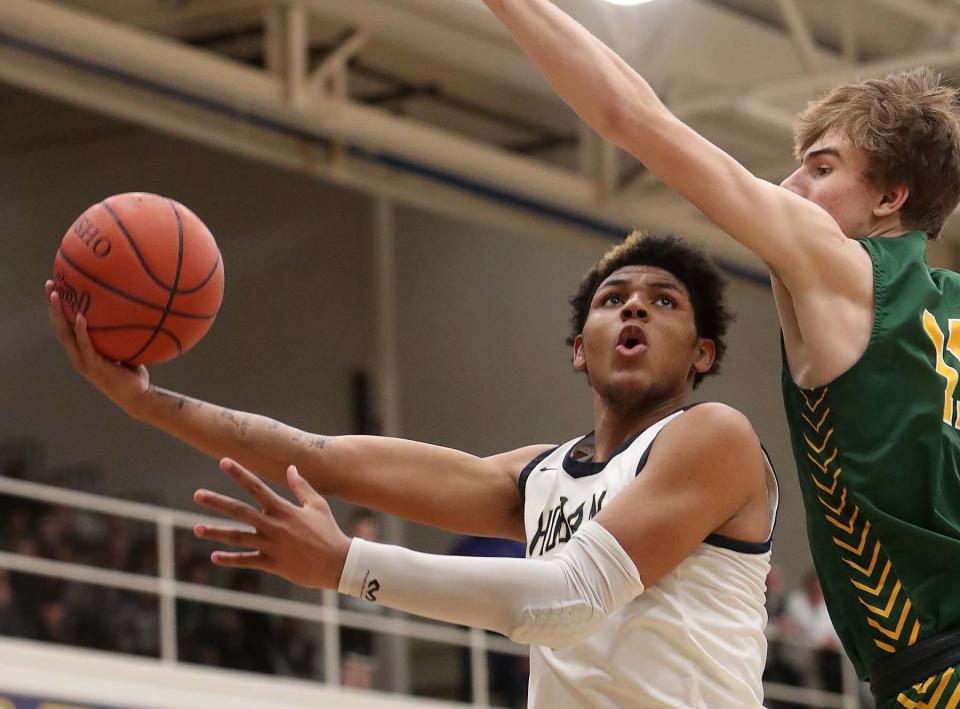 Archbishop Hoban guard Jonas Nichols tries to get a shot off against Lakewood St. Edward's Cam Grant during the third quarter of their Division I regional final Saturday at Copley. St. Edward won 63-46. [Karen Schiely/Beacon Journal]