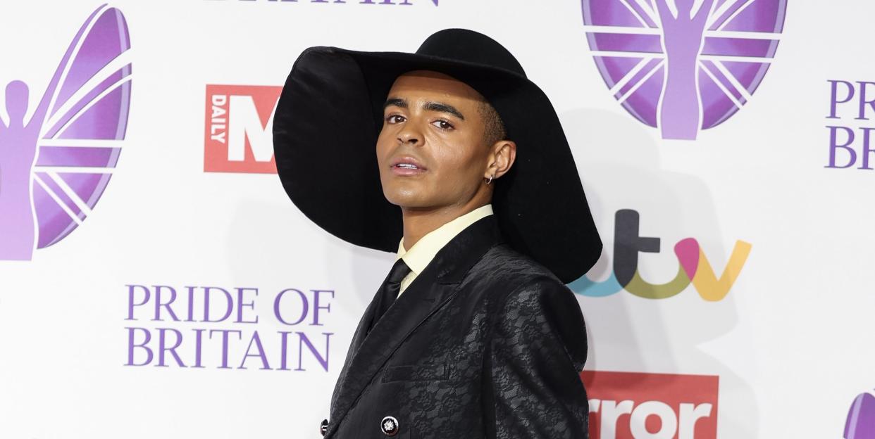 layton williams wearing a leather and lace suit accessorised with a black wide brimmed hat