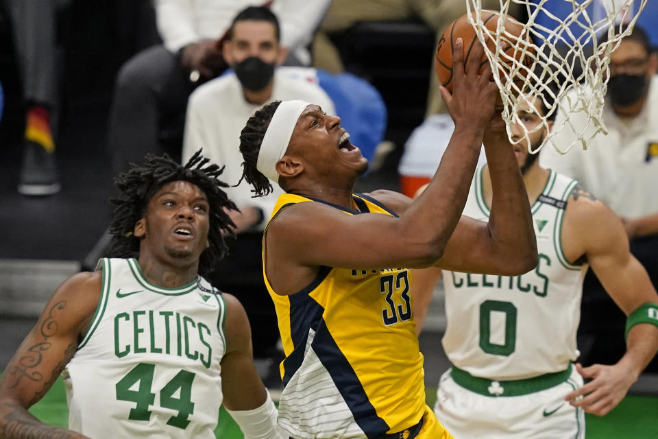 Indiana Pacers center Myles Turner (33) drives to the hoop past Boston Celtics center Robert Williams III (44) in the first quarter of an NBA basketball game, Friday, Feb. 26, 2021, in Boston. (AP Photo/Elise Amendola)