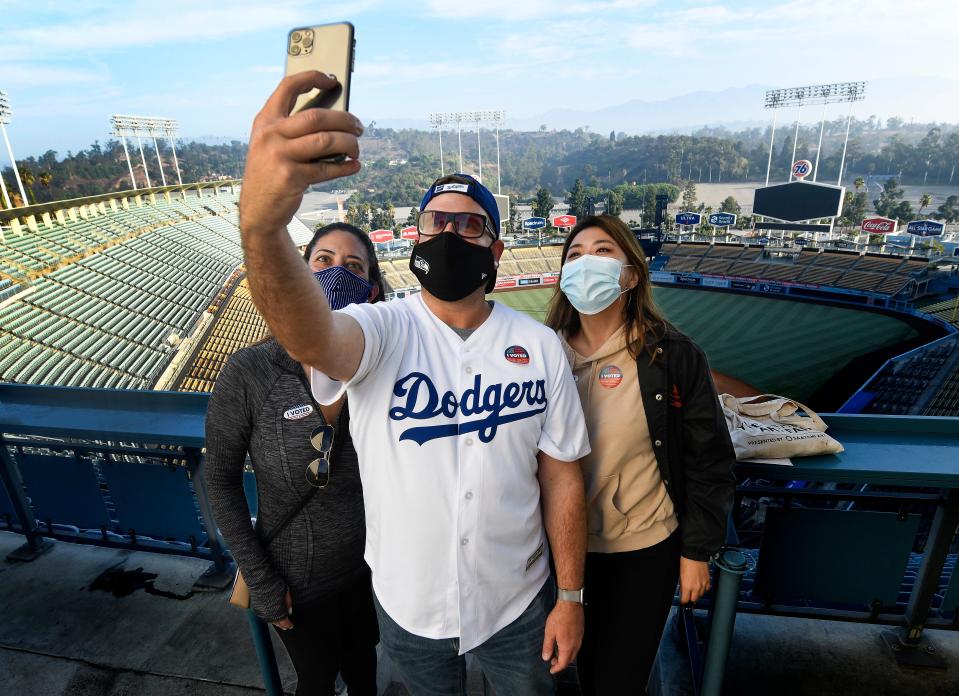 Shaun Butch takes a selfie after voting at Dodger Stadium with Matti Abramson (left) and Katherine Wong on Nov. 3, 2020.