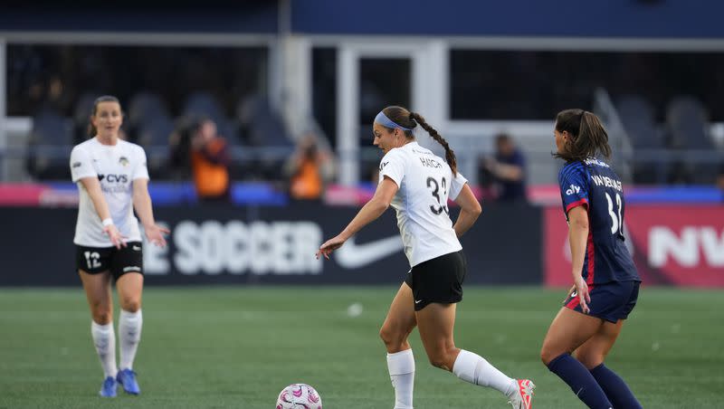 Washington Spirit forward Ashley Hatch moves the ball against OL Reign midfielder Olivia Van der Jagt, right, during the first half of an NWSL soccer match Friday, Oct. 6, 2023, in Seattle.