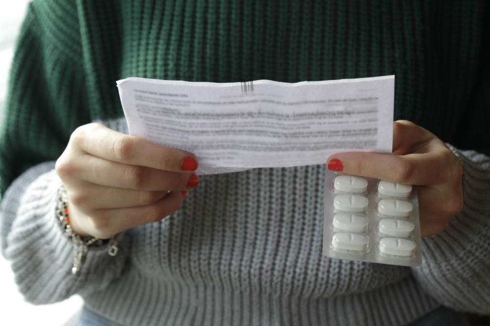 Woman reading antibiotics leaflet. (Getty Images)