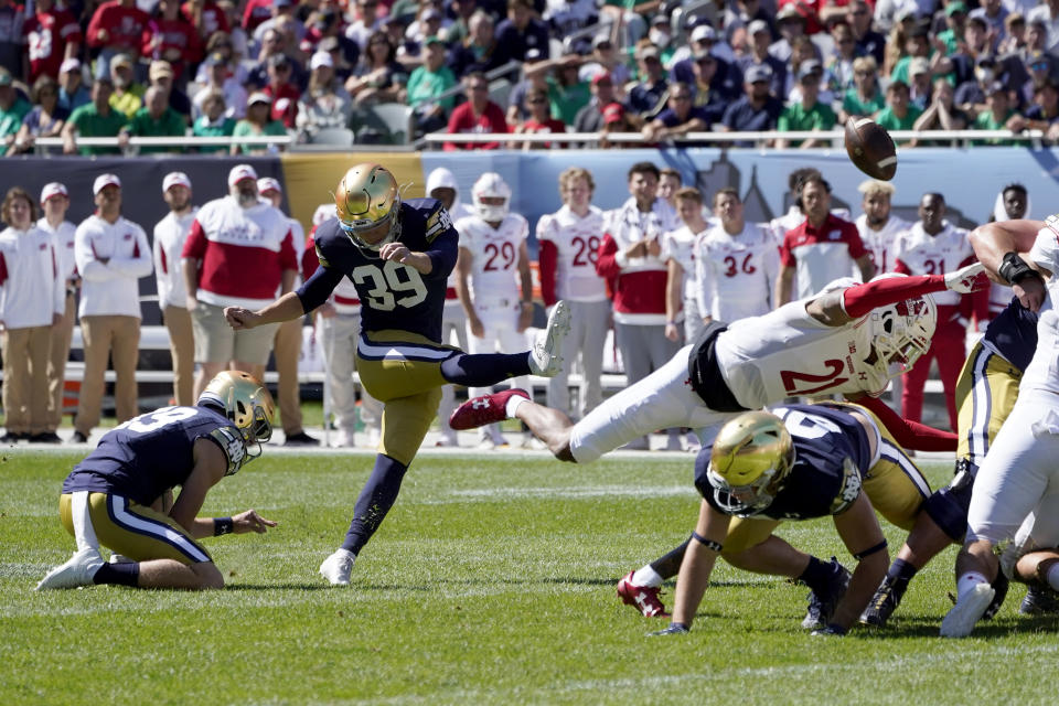 Notre Dame place kicker Jonathan Doerer kicks a field goal off the hold of Jay Bramblett during the first half of an NCAA college football game against Wisconsin Saturday, Sept. 25, 2021, in Chicago. (AP Photo/Charles Rex Arbogast)