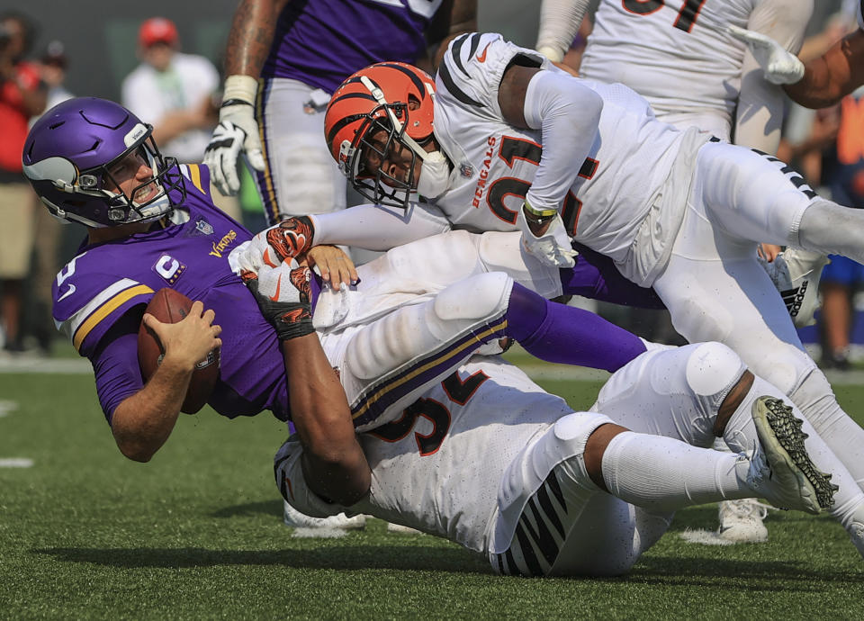 Cincinnati Bengals defensive end Noah Spence (52) and cornerback Mike Hilton (21) sack Minnesota Vikings quarterback Kirk Cousins (8) during the second half of an NFL football game, Sunday, Sept. 12, 2021, in Cincinnati. (AP Photo/Aaron Doster)