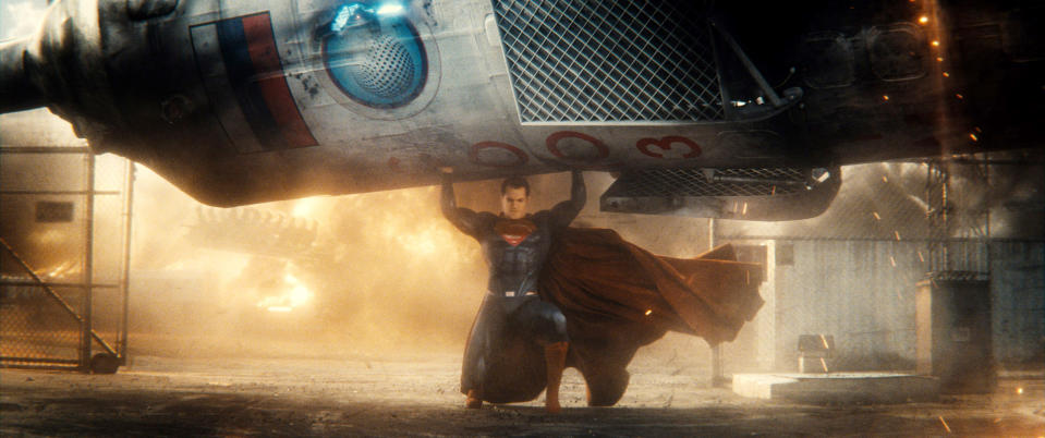 Superman lifts a rocket above his head