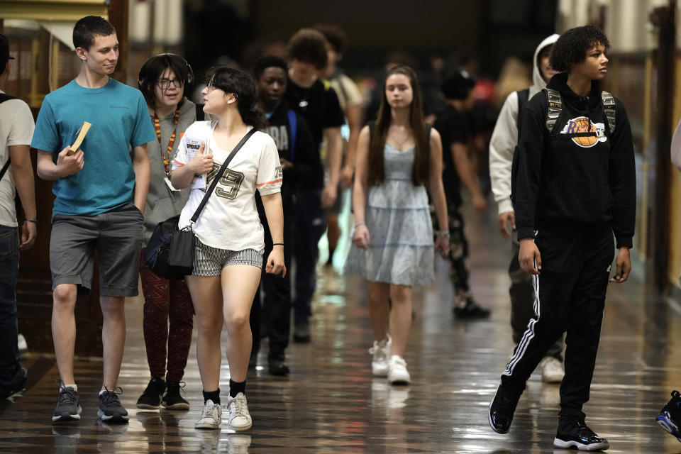 Students mix in a hallway as they change classes at Topeka High school Friday, May 10, 2024, in Topeka, Kan. Topeka is the home of the former Monroe school which was at the center of the Brown v. Board of Education Supreme Court ruling ending segregation in public schools 70 years ago. (AP Photo/Charlie Riedel)