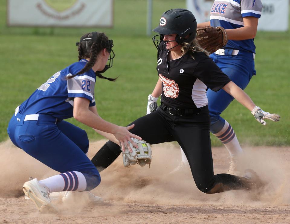 Mallory Gearhart (right) of Green slides into second base on a steal attempt ahead of the tag of Brooklyn Ury of Lake during their Division I district semifinal at Massillon on Monday, May 17, 2021.