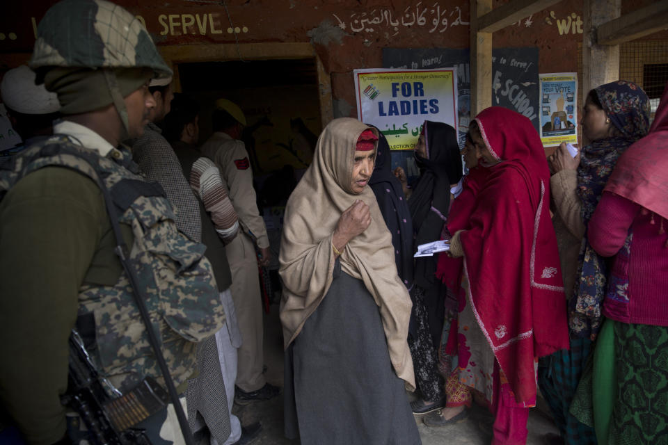 A Kashmiri woman walks out of a polling station after casting her vote during the second phase of India's general elections, in Baba Nagri, about 44 kilometers (28 miles) northeast of Srinagar, Indian controlled Kashmir, Thursday, April 18, 2019. Kashmiri separatist leaders who challenge India's sovereignty over the disputed region have called for a boycott of the vote. Most polling stations in Srinagar and Budgam areas of Kashmir looked deserted in the morning with more armed police, paramilitary soldiers and election staff present than voters. (AP Photo/ Dar Yasin)