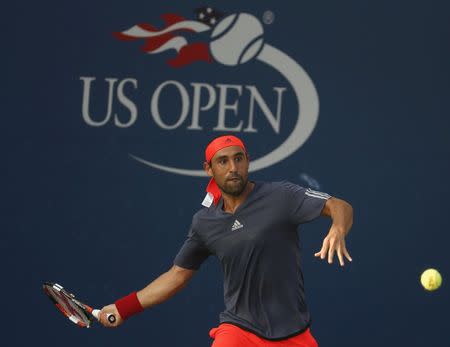 Cyprus' Marcos Baghdatis returns to Belgium's Steve Darcis in their first round match at the U.S. Open Championships tennis tournament in New York September 1, 2015. REUTERS/Shannon Stapleton Picture Supplied by Action Images