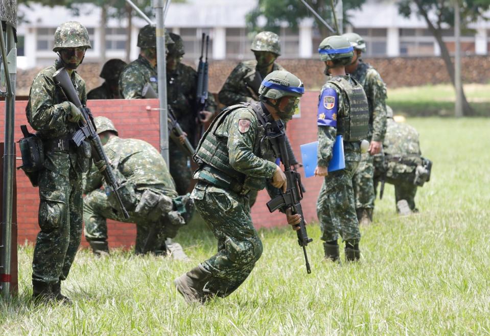Taiwanese soldiers holding firearms take part in a military training in Taichung (AP)