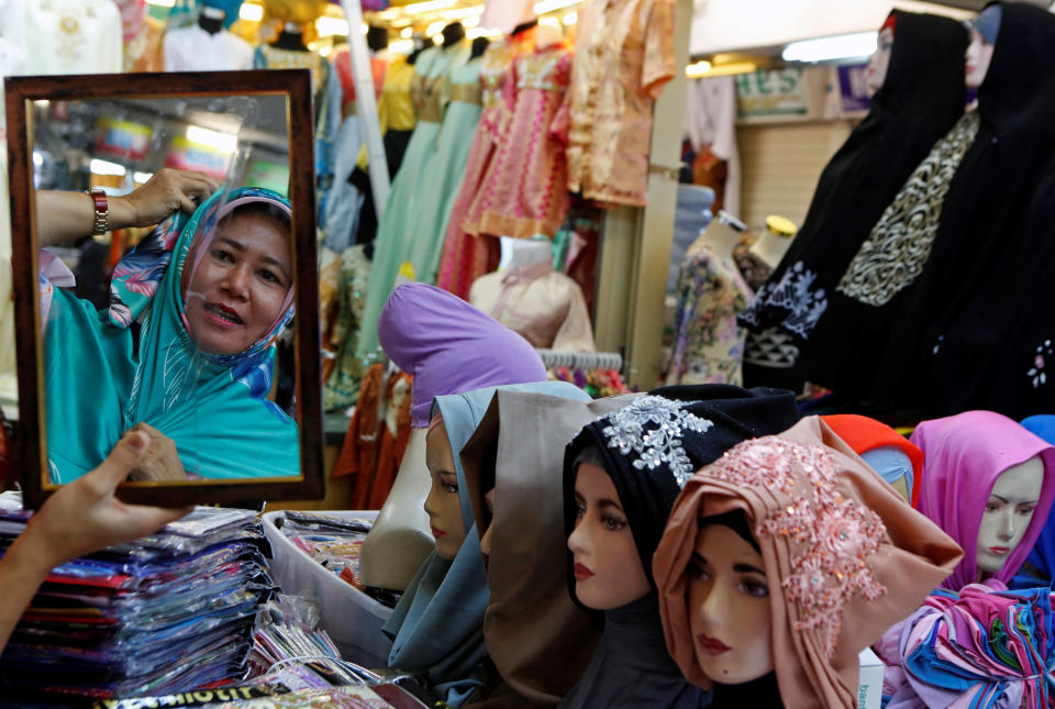 A woman shops for head scarves at Tanah Abang Textile Market ahead of the Muslim holiday of Eid al-Fitr, marking the end of Ramadan, in Jakarta, Indonesia June 20, 2017. REUTERS/Agoes Rudianto