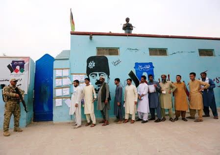 Men arrive to cast their votes outside a polling station in the presidential election in Jalalabad, Afghanistan