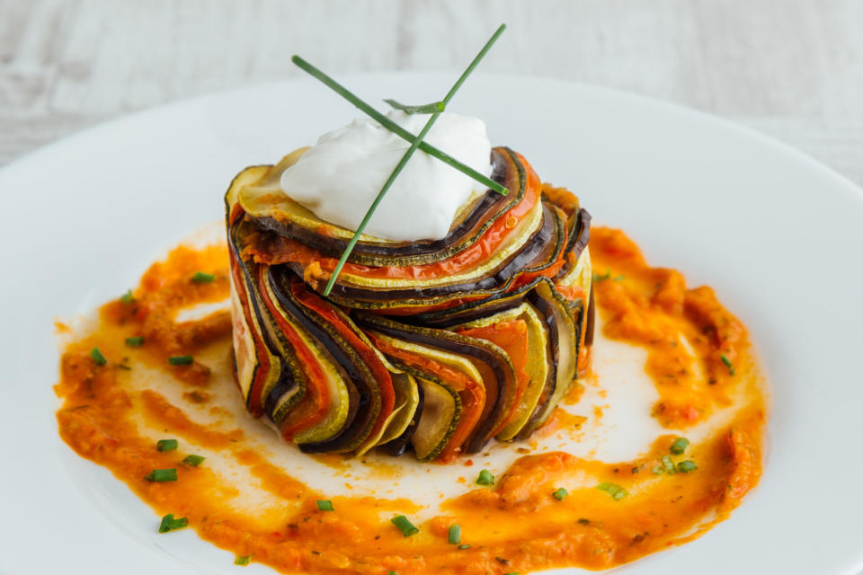 A stacked cylinder of thinly sliced vegetables