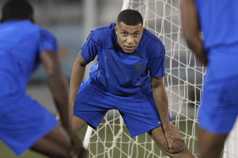 France's Kylian Mbappe stretches during a training session in Doha, Qatar, Tuesday, Dec. 13, 2022 on the eve of their World Cup semifinal soccer match against Morocco. (AP Photo/Christophe Ena)