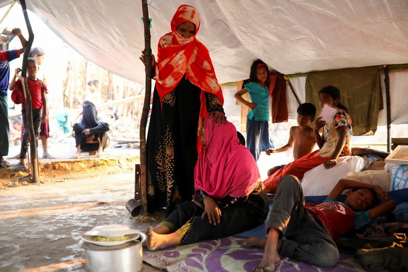 The Wider Image: 'Can't take this pain': Rohingya mother searches for son after refugee camp blaze