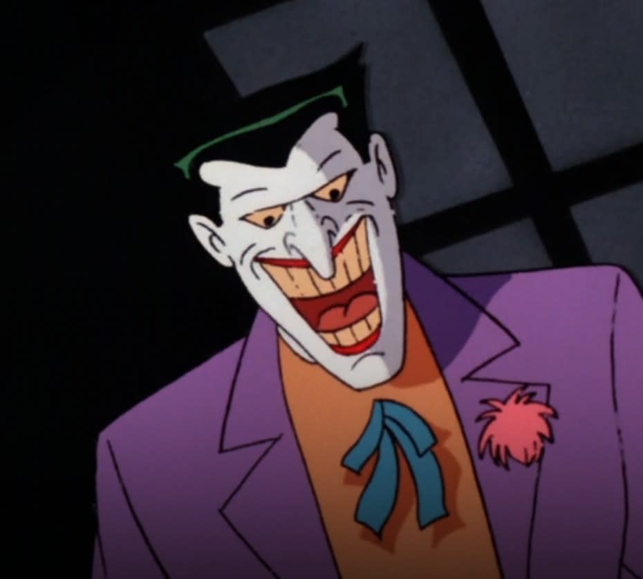 The Joker smiles over Charlie, a man he's kidnapped with Harley Quinn