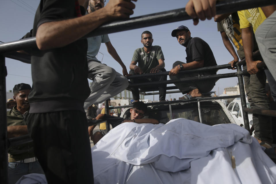 Palestinians transport the bodies of their relatives killed in an Israeli bombardment where displaced people were staying in Rafah, Gaza Strip, Tuesday, May 28, 2024. (AP Photo/Jehad Alshrafi)