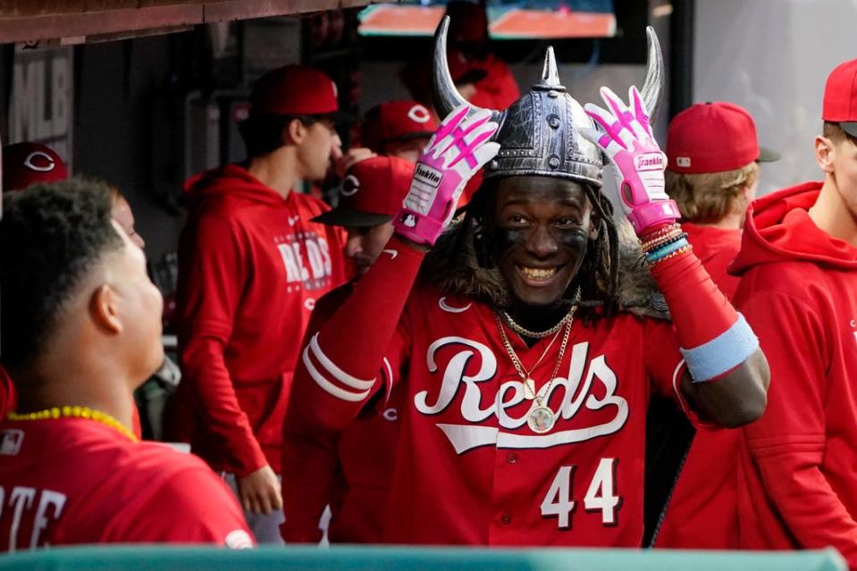 Cincinnati Reds' Elly De La Cruz (44) celebrates with Noelvi Marte, left, in the dugout after hitting a home run against the Cleveland Guardians during the fourth inning of a baseball game Tuesday, Sept. 26, 2023, in Cleveland. (AP Photo/Sue Ogrocki)