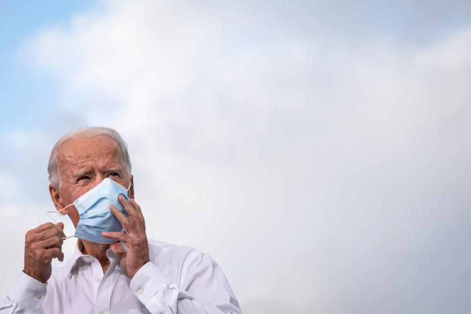 Joe Biden puts on a mask. He was the subject of a misleading tweet.