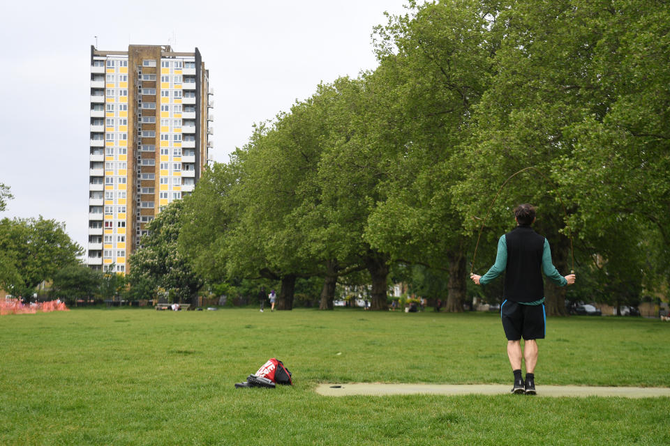 A man exercising on London Fields, in London, as the UK continues in lockdown to help curb the spread of the coronavirus.