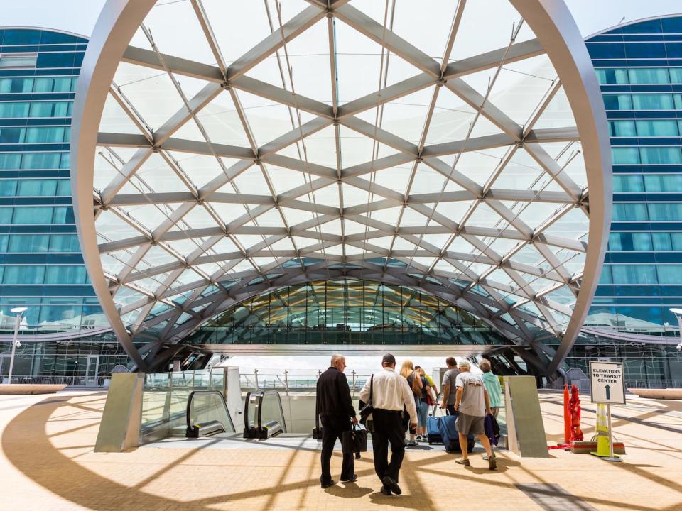 Travelers walk through the Denver International Airport